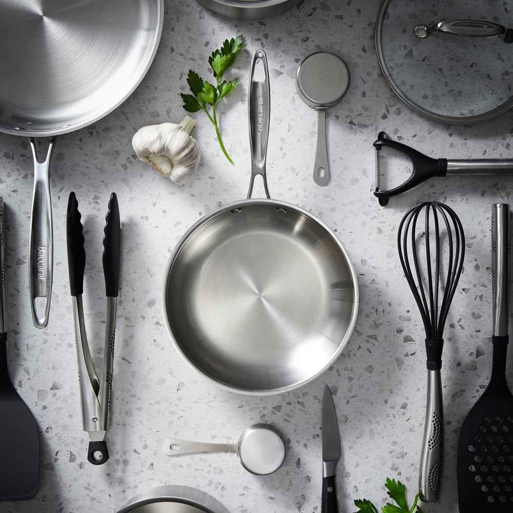 a steel pan on a wooden board with pastel tableware and pancakes with berries - Baccarat