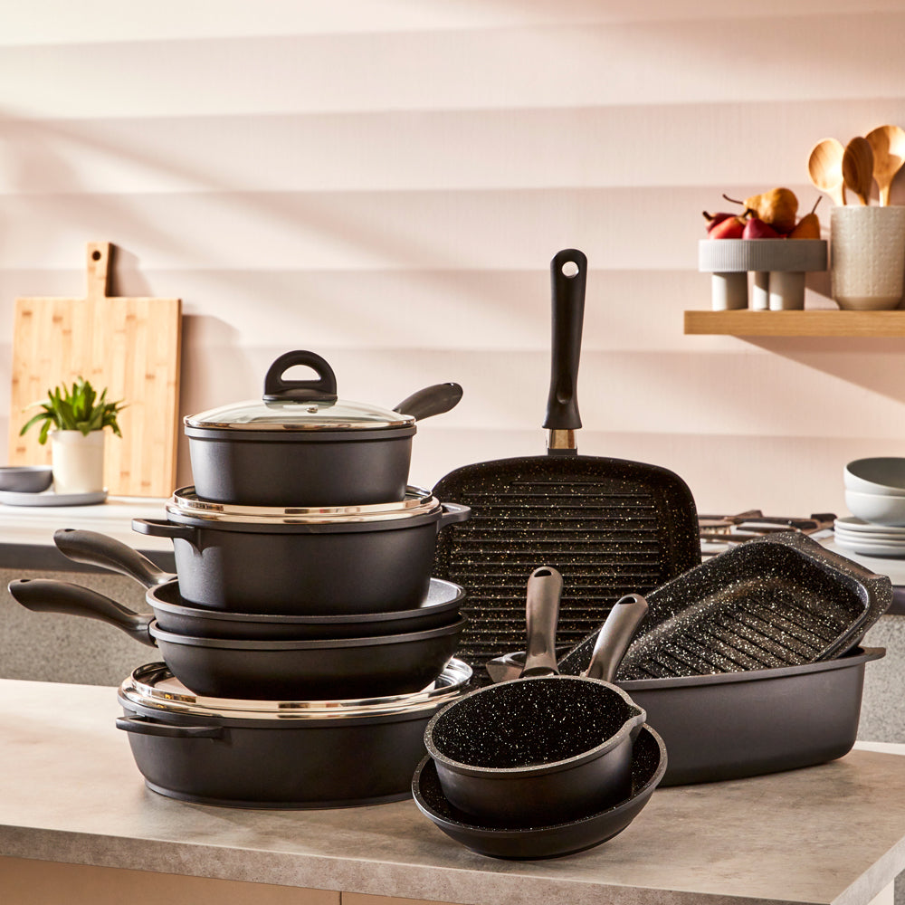 A modern kitchen featuring a sleek stir fry pan and cookware set in stone finish - Baccarat