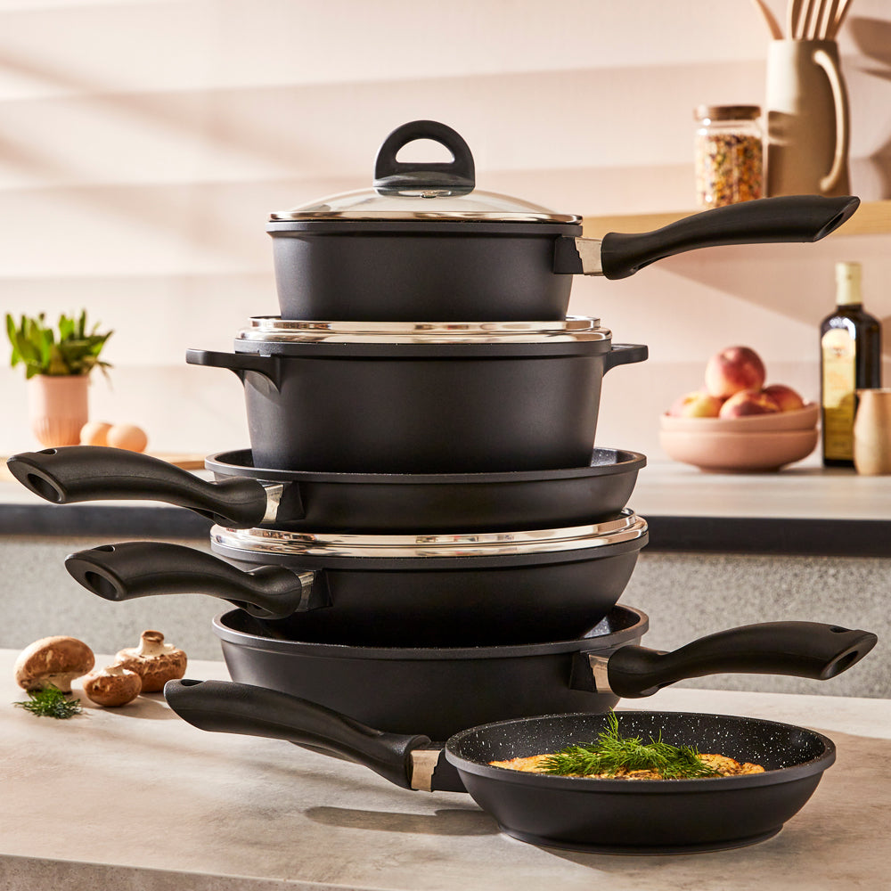 A complete cookware set with non-stick pans and pots featuring sleek black surfaces - Baccarat