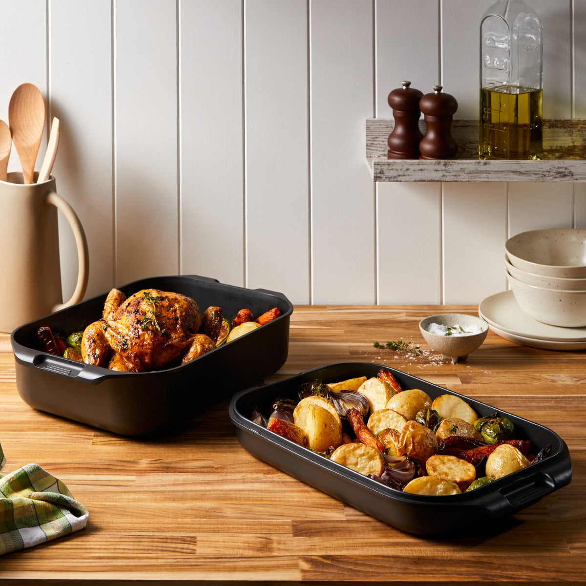A roasted chicken with vegetables in a nonstick multi pan on a wooden table - Baccarat