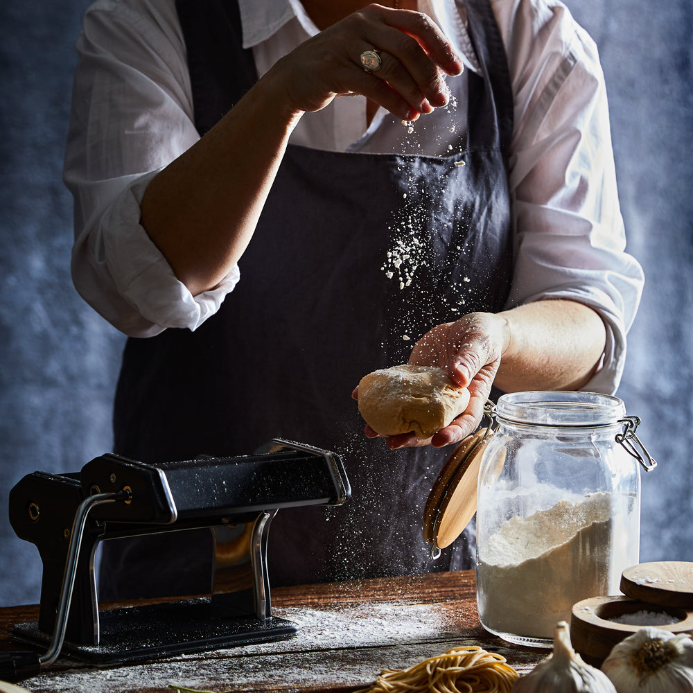 A person creating fresh golden pasta in a cozy kitchen - Baccarat gourmet 150mm pasta machine black