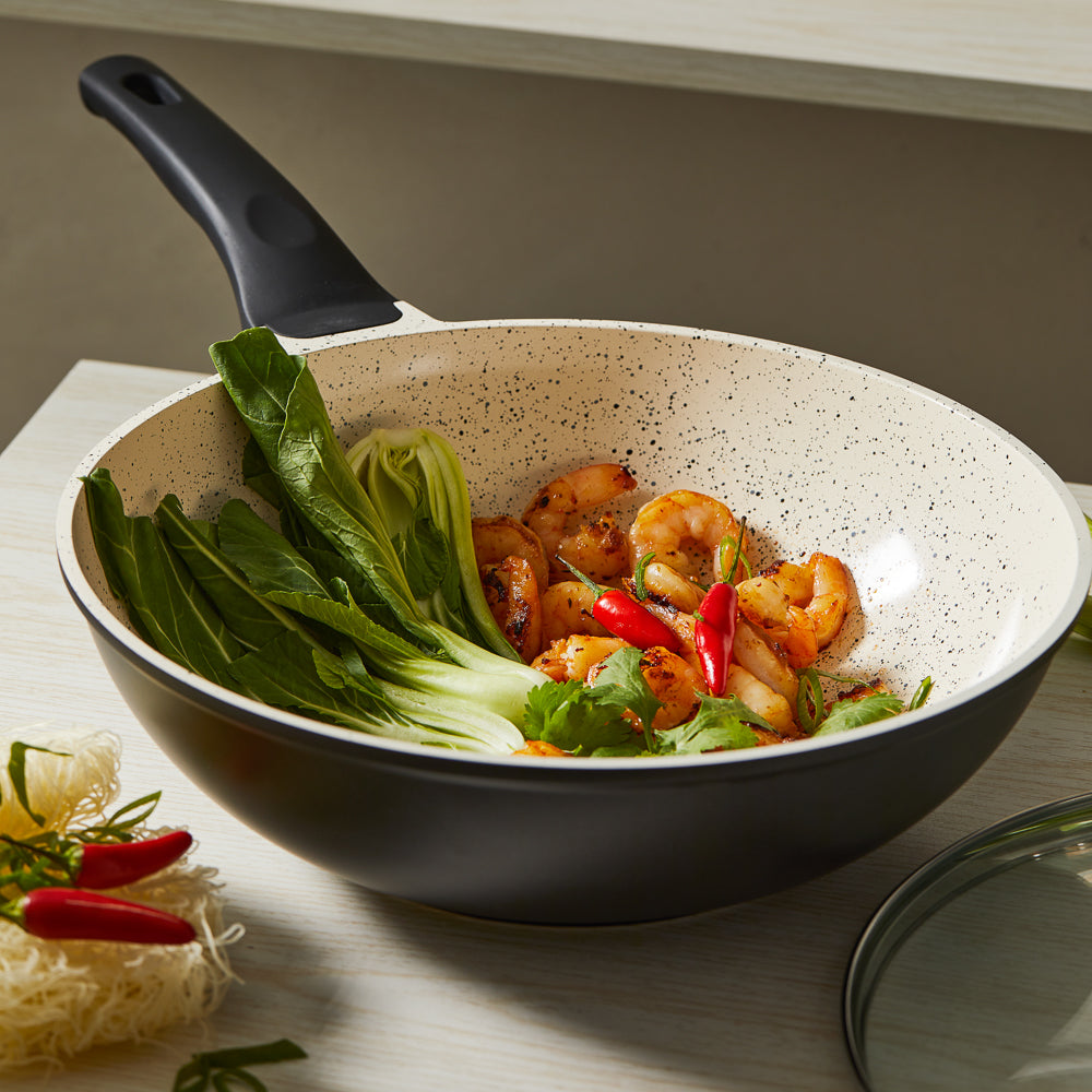 Stir frying colourful vegetables in a black ceramic pan with a glass lid - Baccarat ceramix stirfry