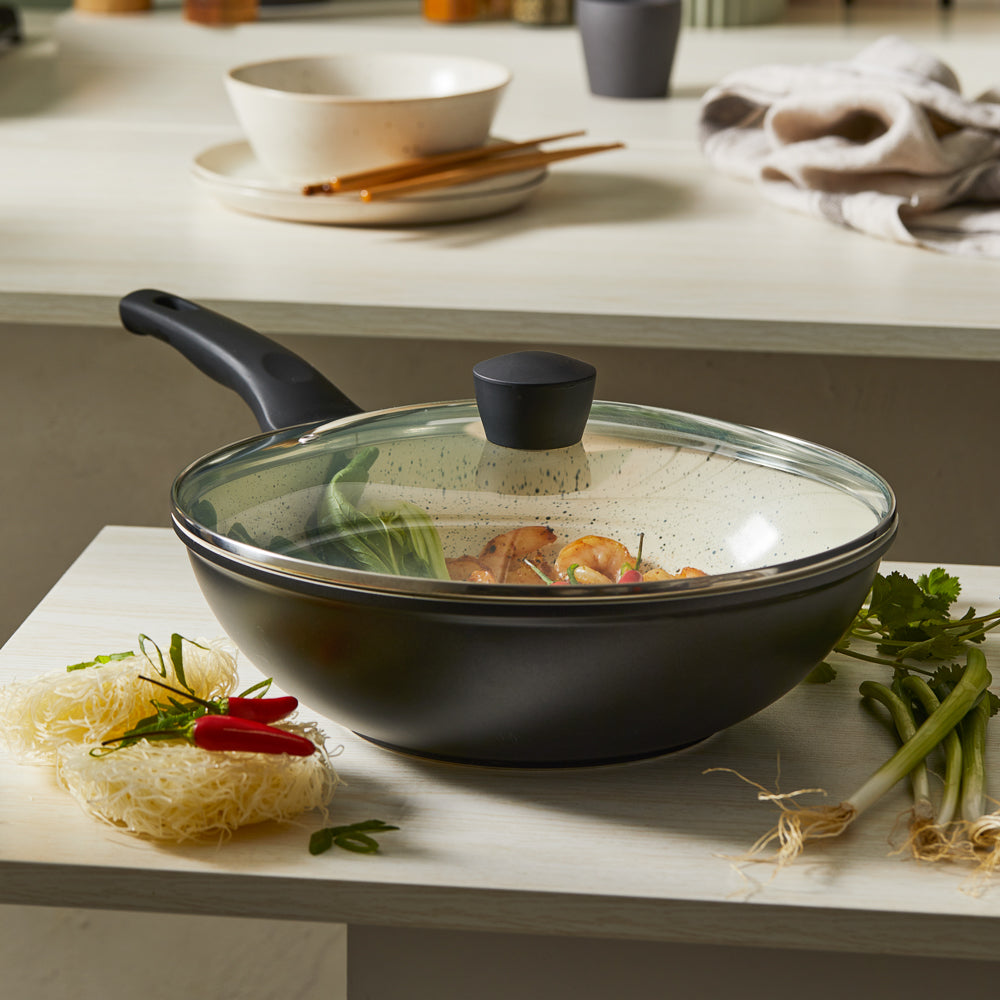 Stir frying colourful vegetables in a black ceramic pan with a glass lid - Baccarat ceramix stirfry