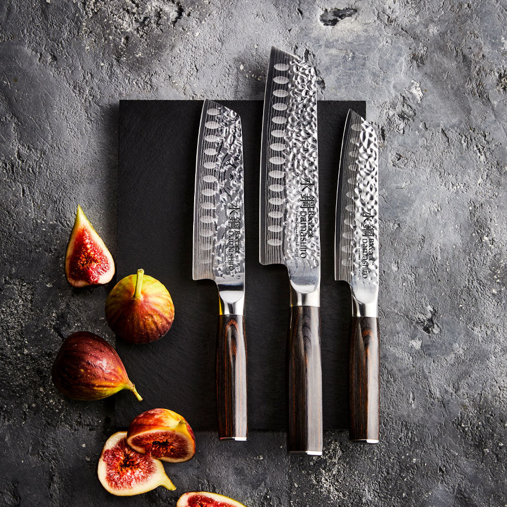 A decorative box with 3-piece knives featuring silver blades and dark handles - Baccarat damashiro