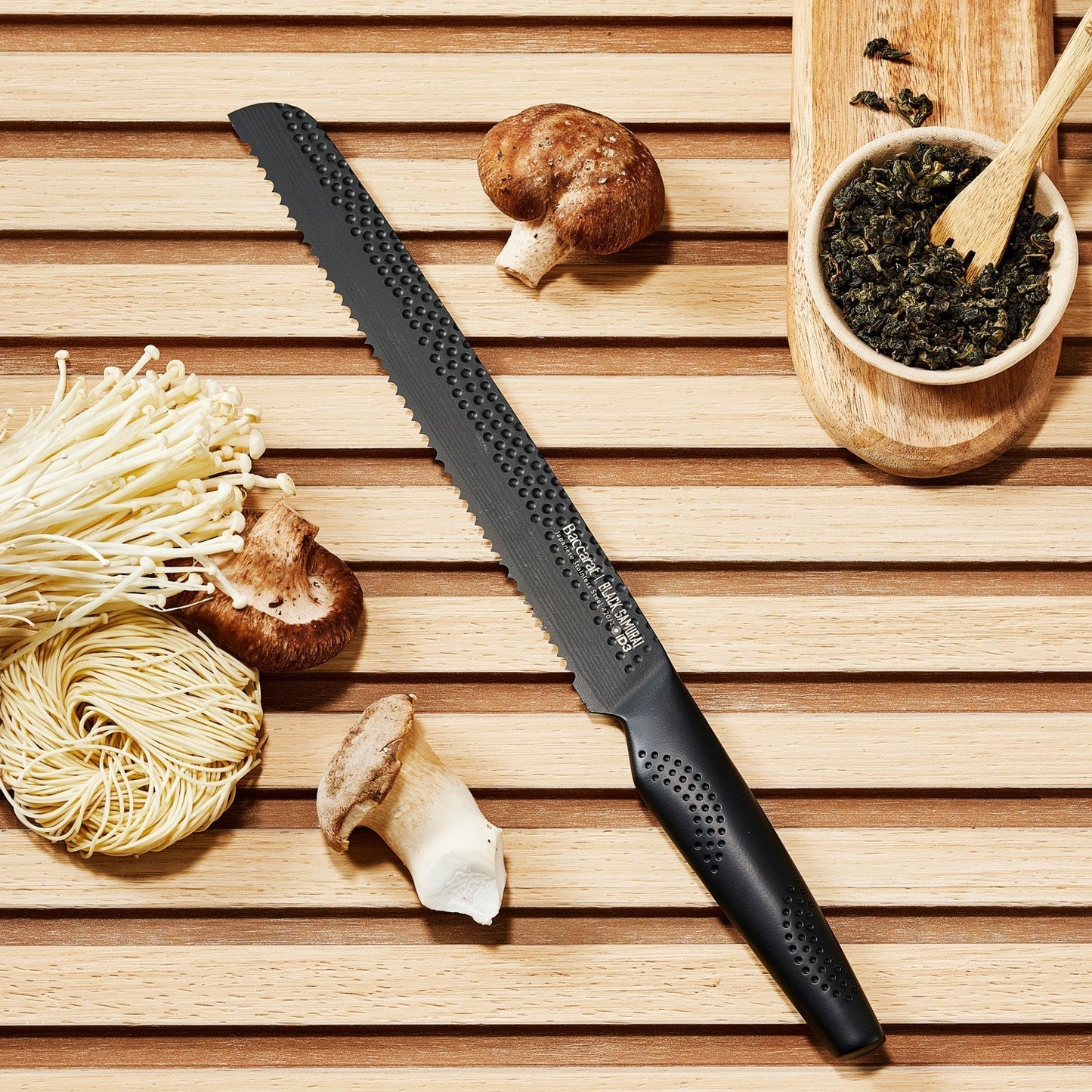 sleek black carving knife on a wooden board with noodles and mushrooms - Baccarat id3 black Samurai