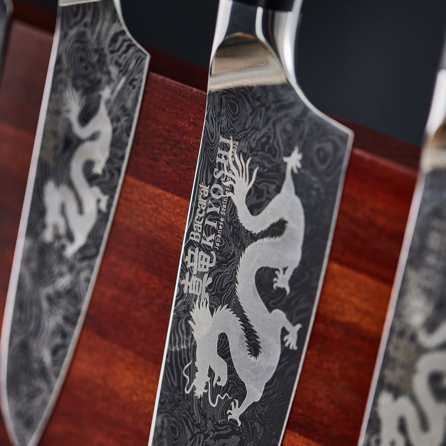 Person chopping ginger and garlic on black cutting board with black Samurai cleaver knife - Baccarat