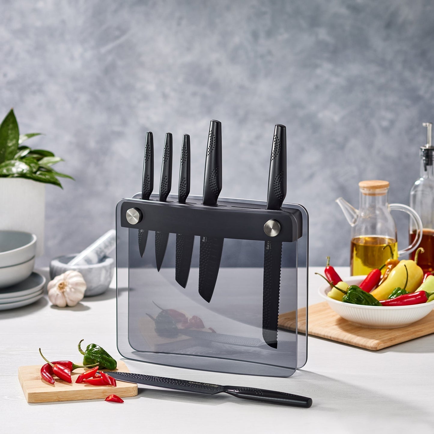 A Baccarat id3 Black Samurai Sakai knife block displaying transparent walls with fresh vegetables