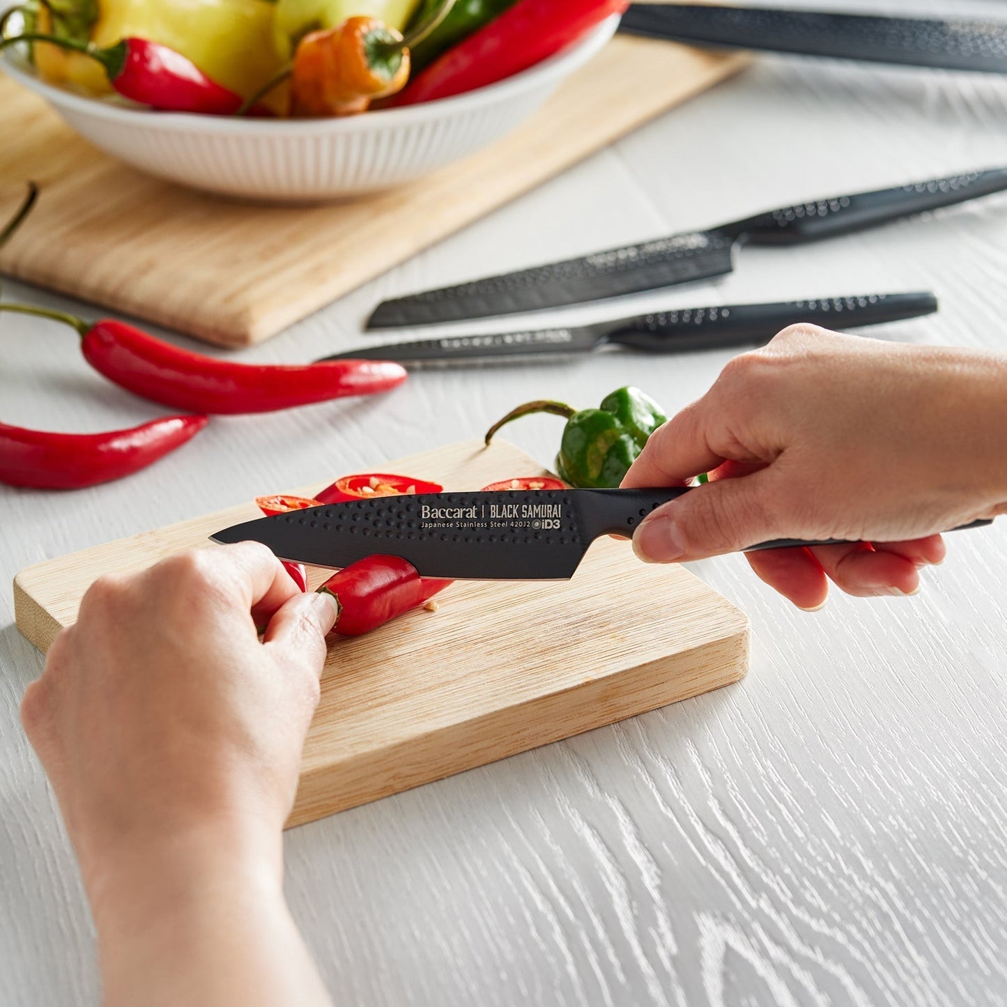 A Baccarat id3 Black Samurai Sakai knife block displaying transparent walls with fresh vegetables