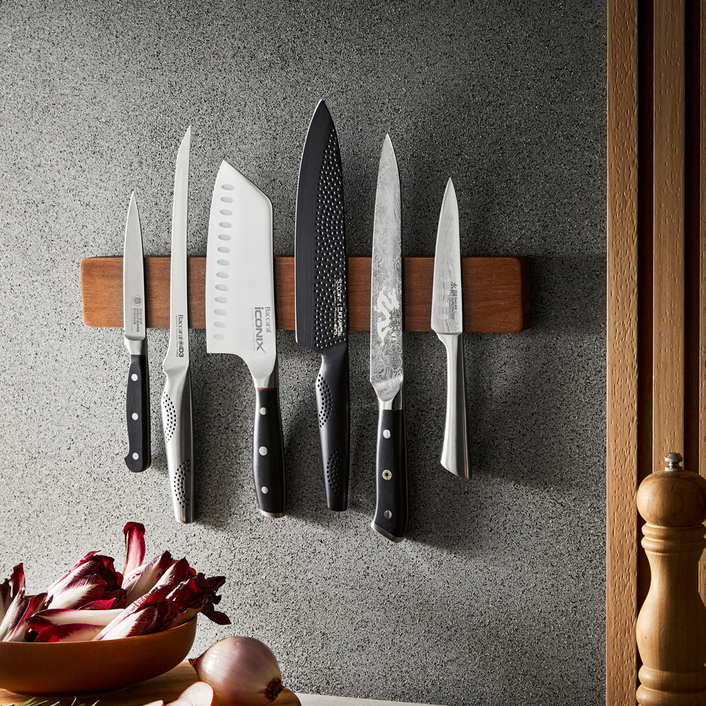 Magnetic acacia wood wall mounted knife holder displaying knives with black handles - Baccarat