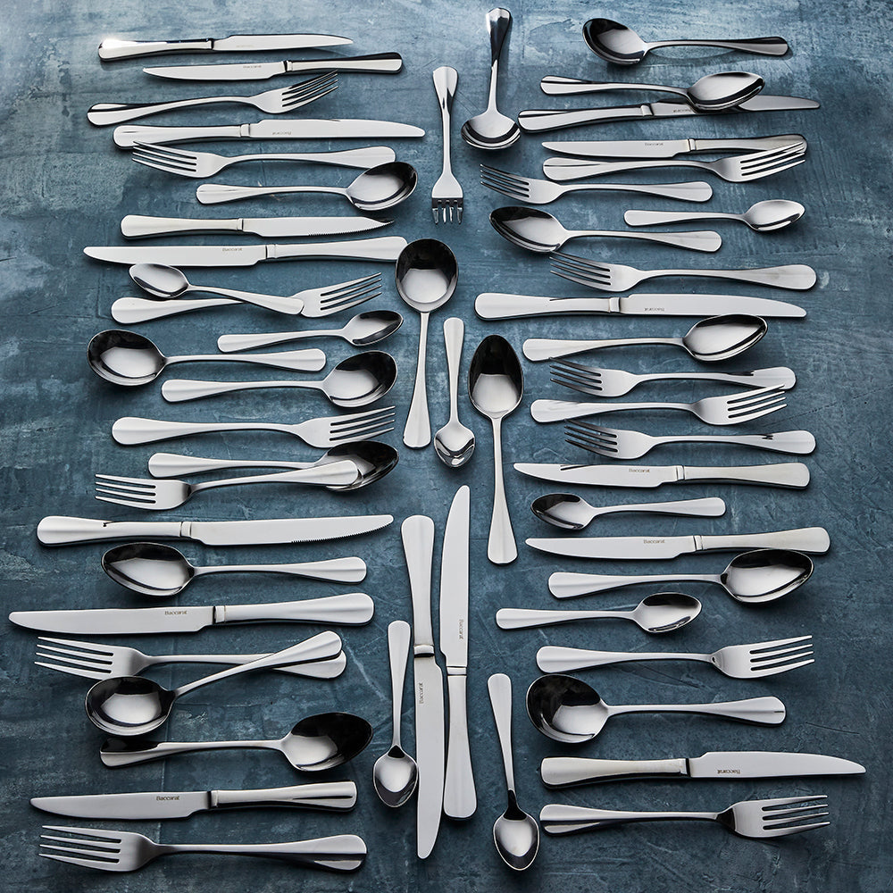 Elegant stainless steel cutlery pieces arranged with forks knives and spoons - Baccarat Royce