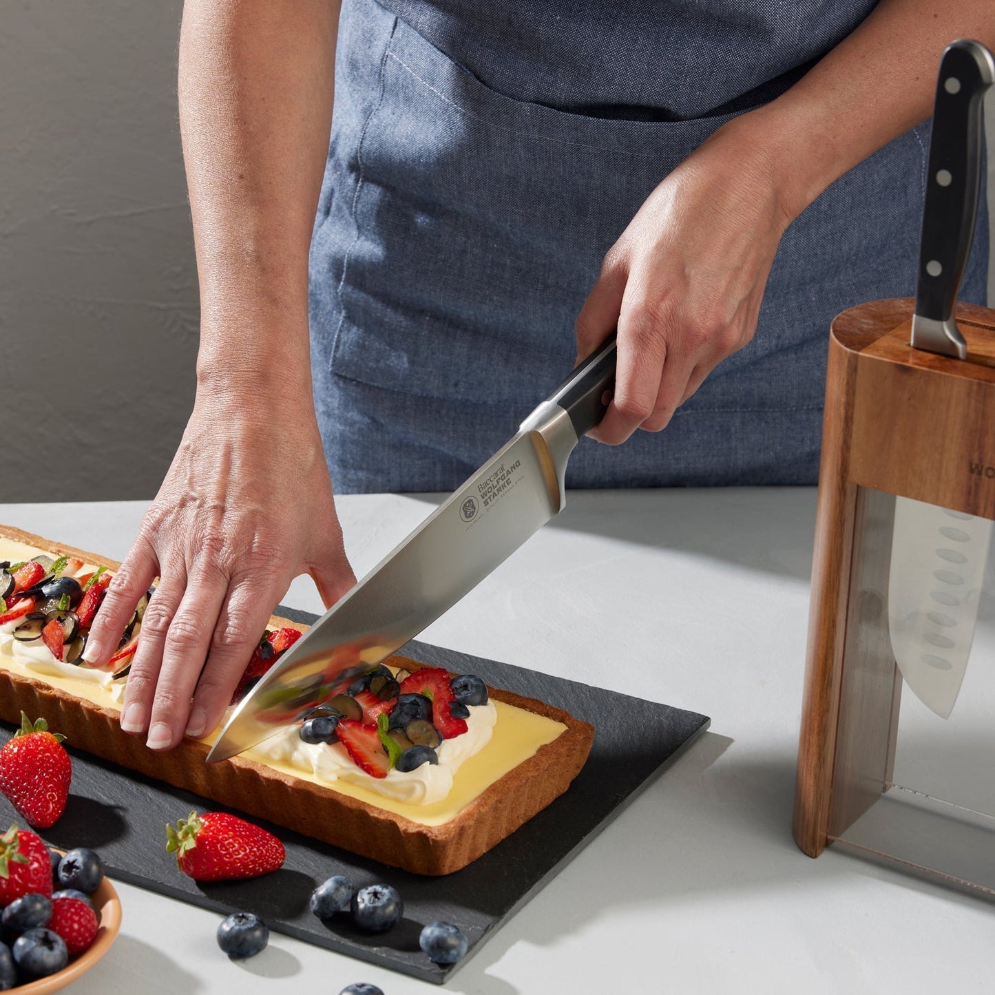 Wooden Baccarat Wolfgang Starke Klar 7-Piece Knife Block on table with strawberries and cheese board