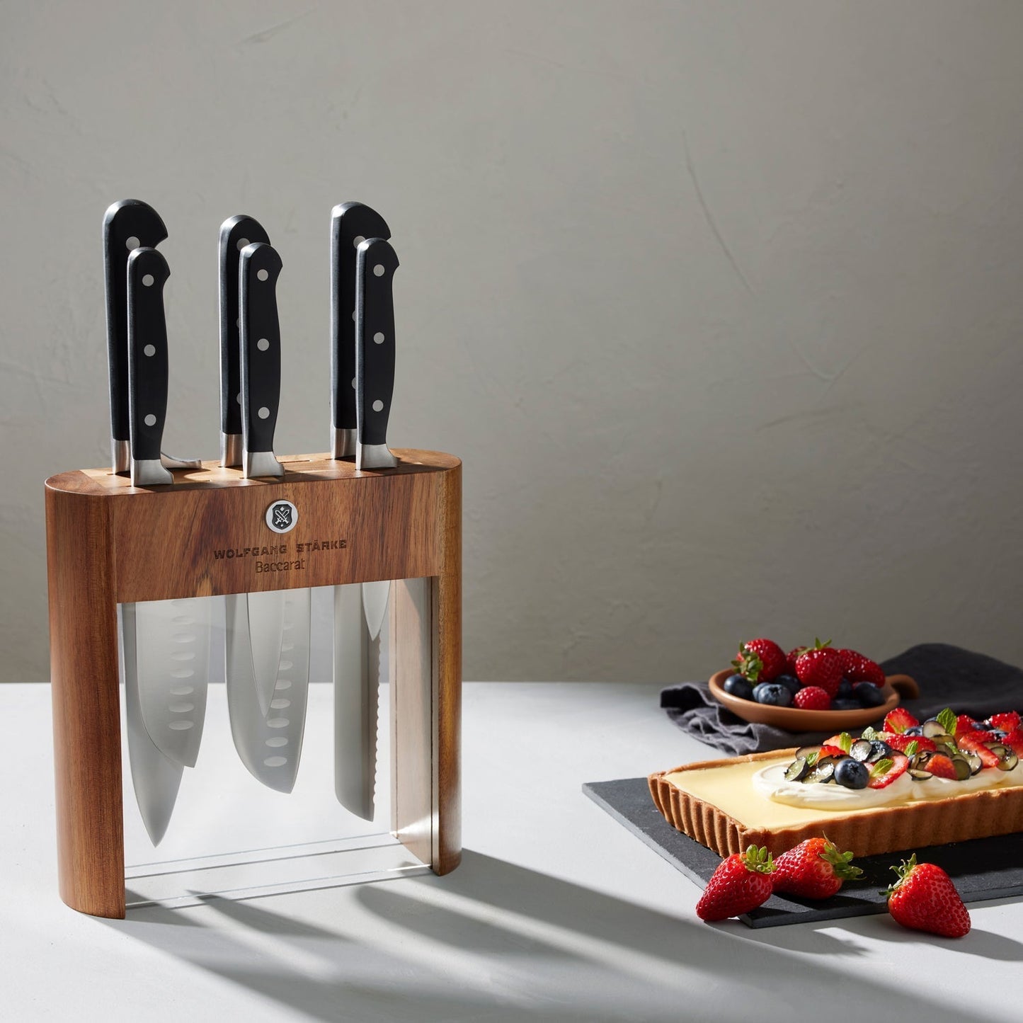 Wooden Baccarat Wolfgang Starke Klar 7-Piece Knife Block on table with strawberries and cheese board