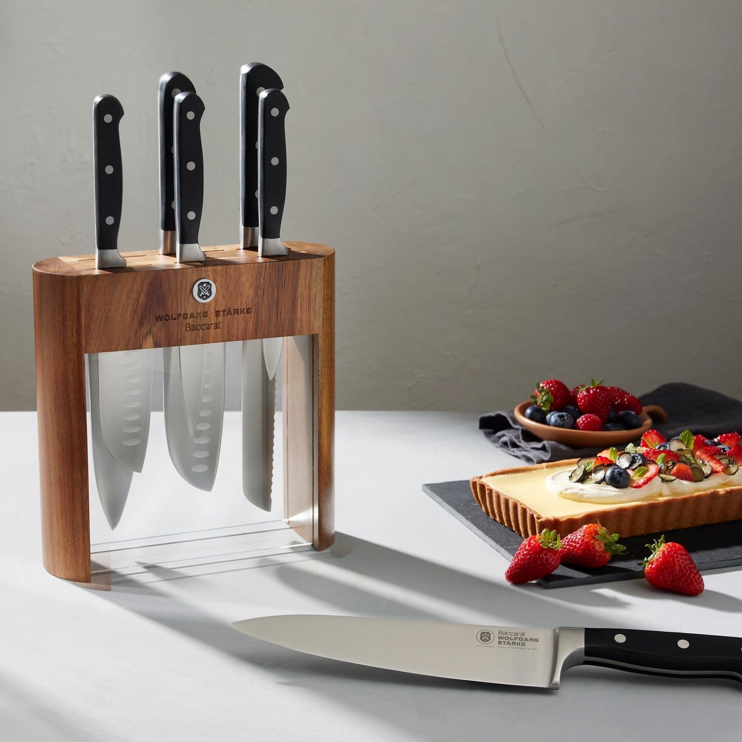 Wooden Baccarat Wolfgang Starke Klar 7-Piece Knife Block on table with strawberries and cheese board