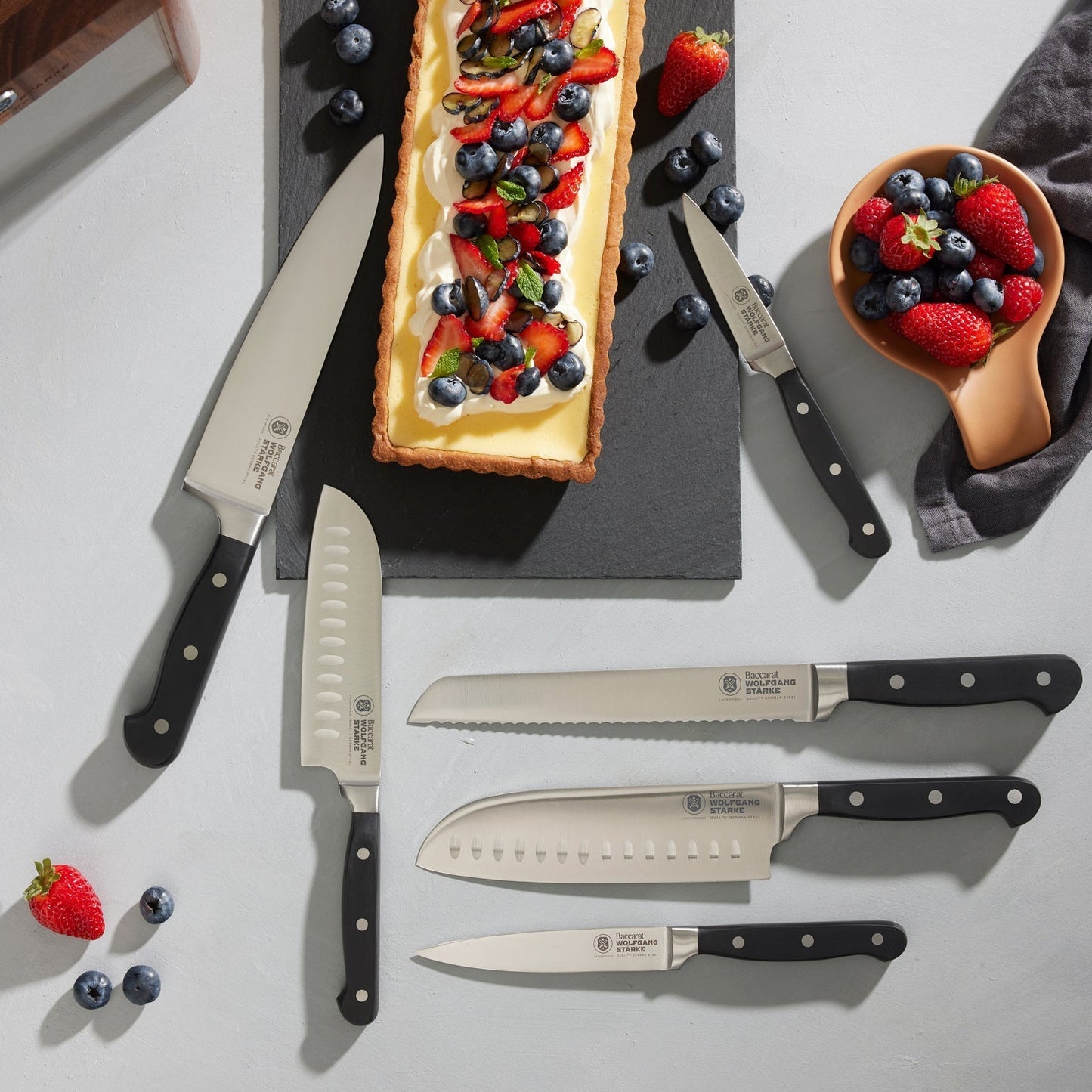 Wooden Baccarat Wolfgang Starke Klar 7-Piece Knife Block on table with strawberries and cheese board