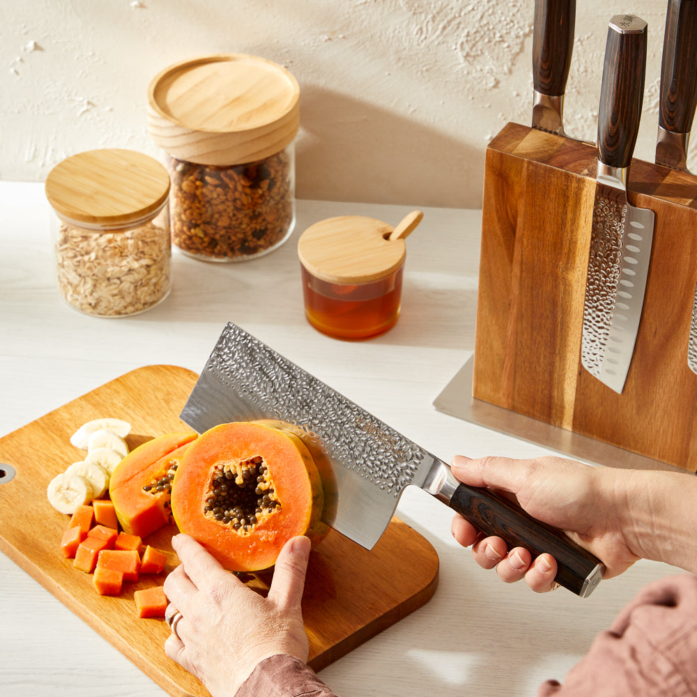 Person slicing ripe papaya on wooden board with knife block set - Baccarat damashiro emperor nanashi