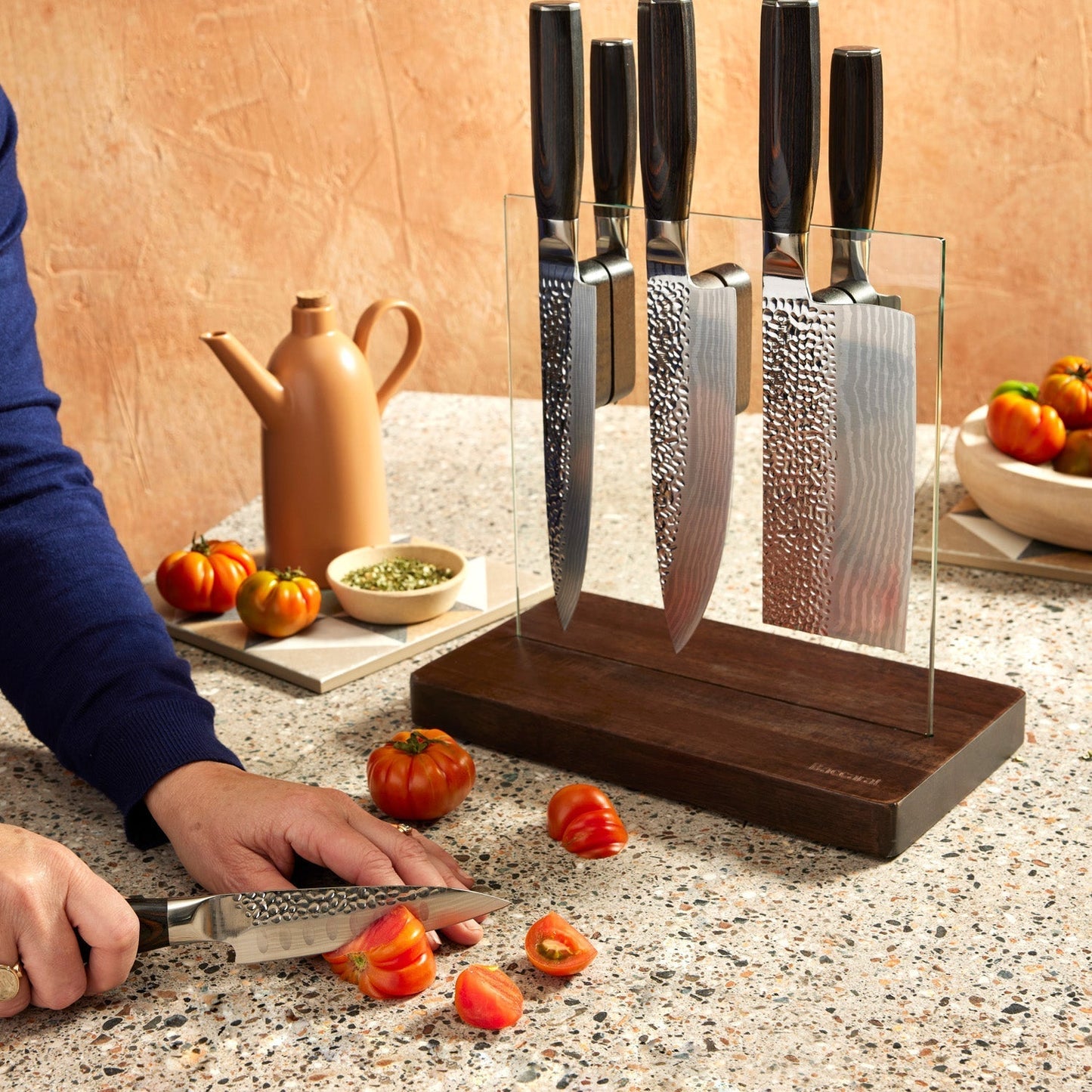 A knife on a wooden board with sleek blades on a countertop - Part of 7-piece knife block - Baccarat