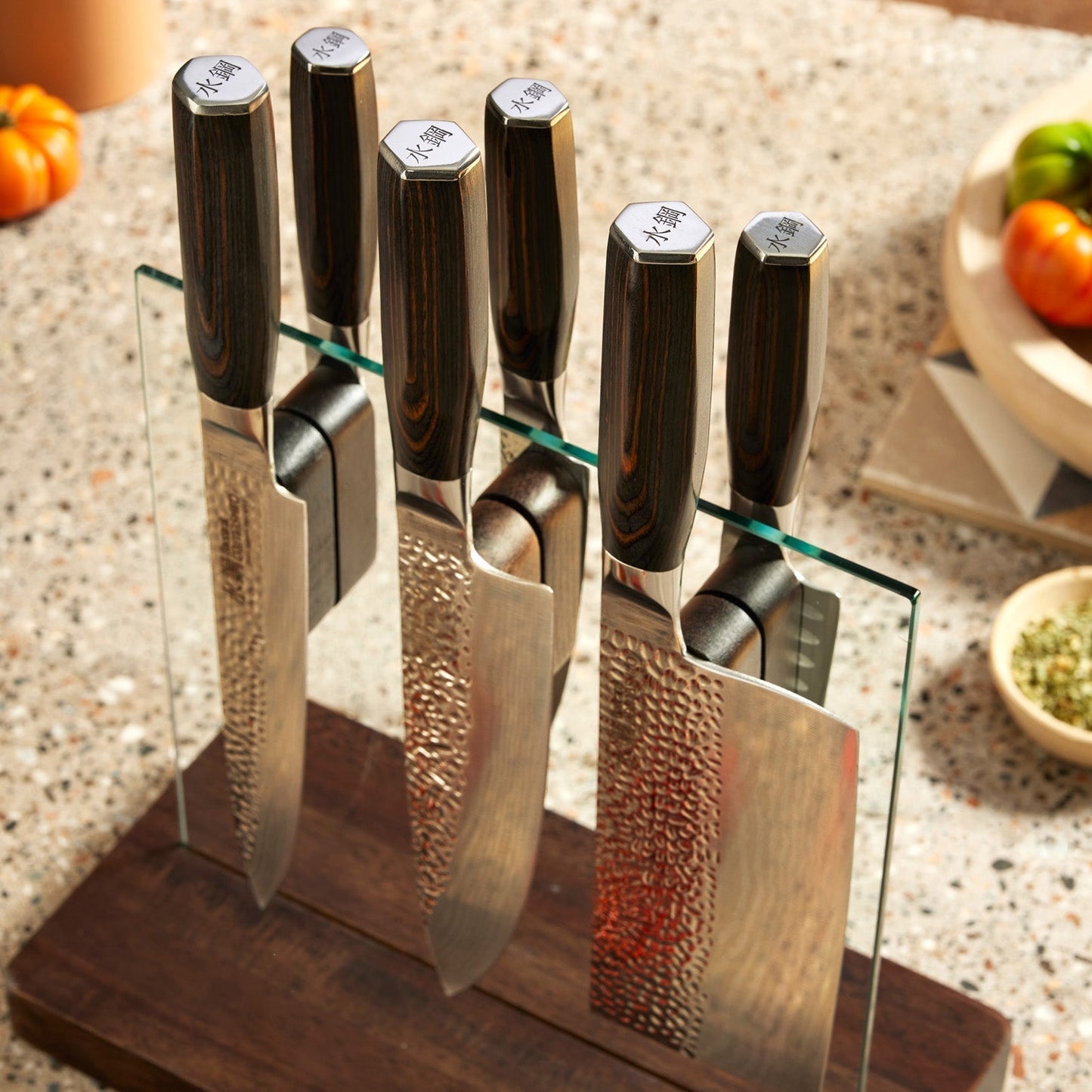 A knife on a wooden board with sleek blades on a countertop - Part of 7-piece knife block - Baccarat