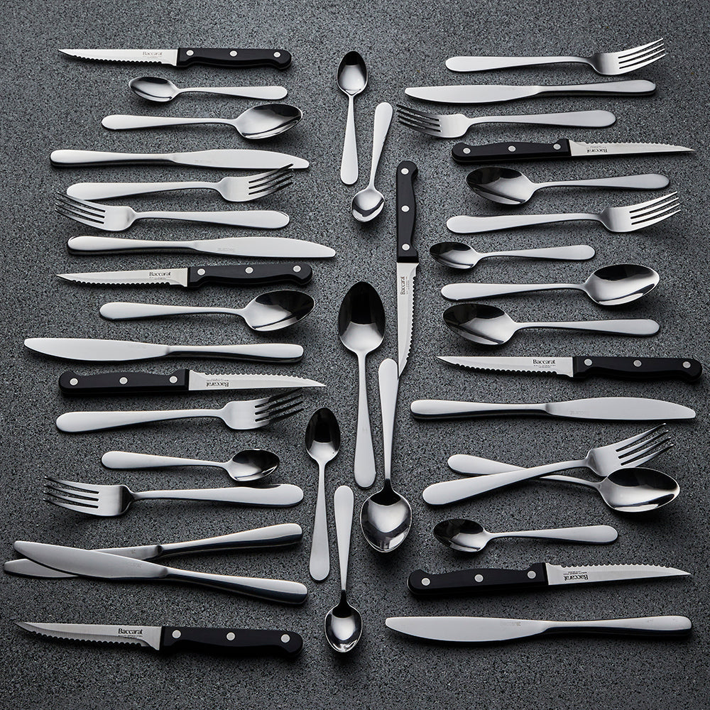 Elegant sabre Fussen 40 piece stainless cutlery set beautifully displayed on dark surface - Baccarat