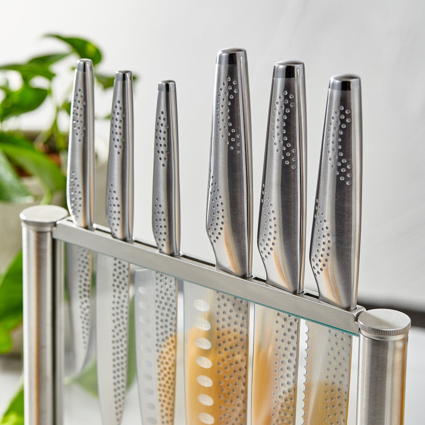 A polished knife block set with sharp blades and sleek design next to fresh vegetables - Baccarat