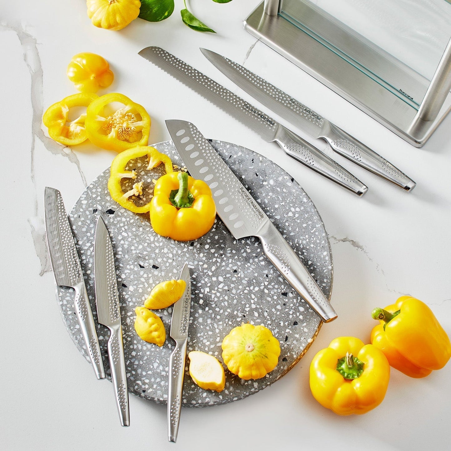 A polished knife block set with sharp blades and sleek design next to fresh vegetables - Baccarat