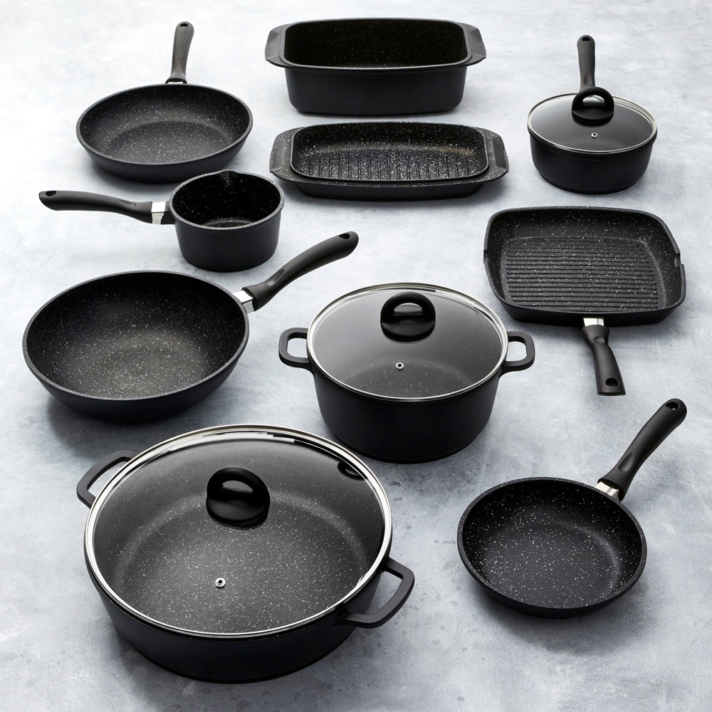 A modern kitchen featuring a sleek stir fry pan and cookware set in stone finish - Baccarat