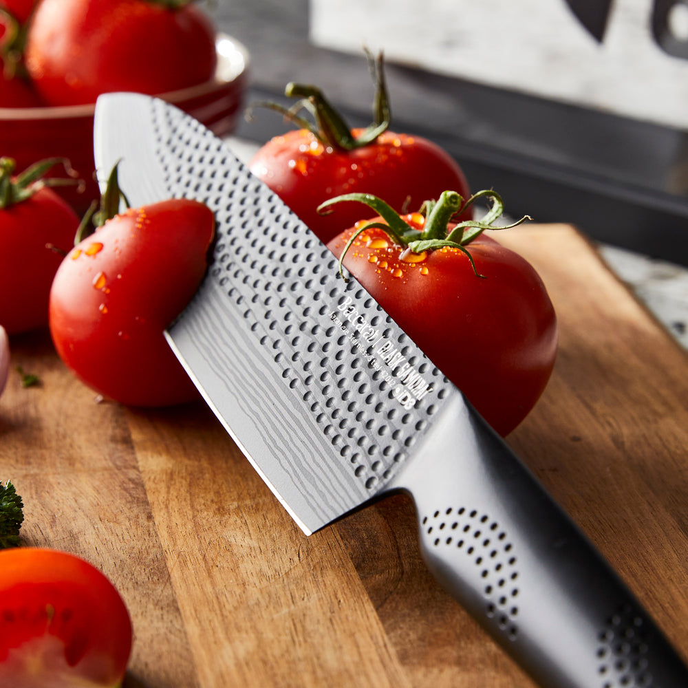 Sharp knives on speckled countertop with sliced tomatoes and onions - Baccarat id3 Black Samurai Syo
