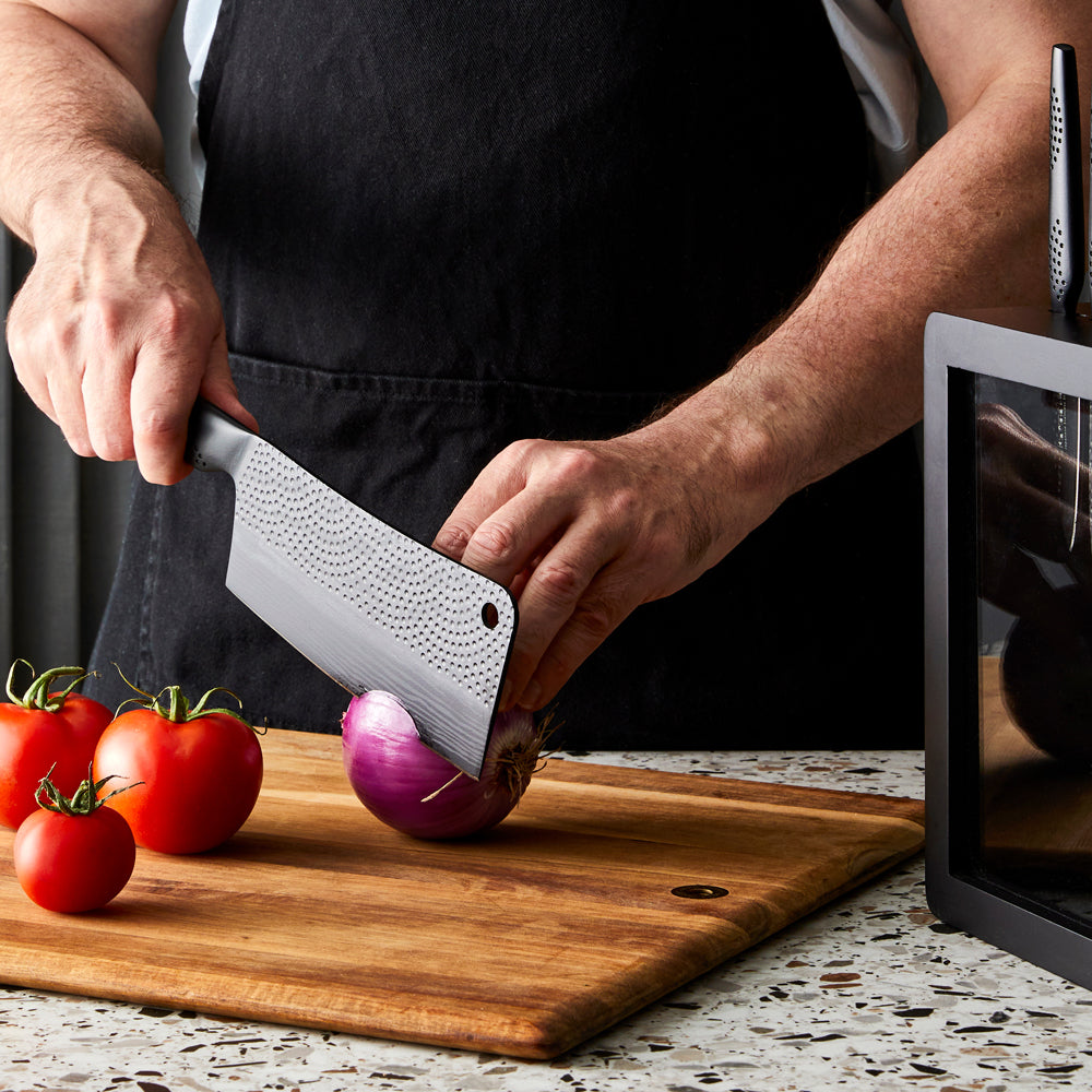 Sharp knives on speckled countertop with sliced tomatoes and onions - Baccarat id3 Black Samurai Syo