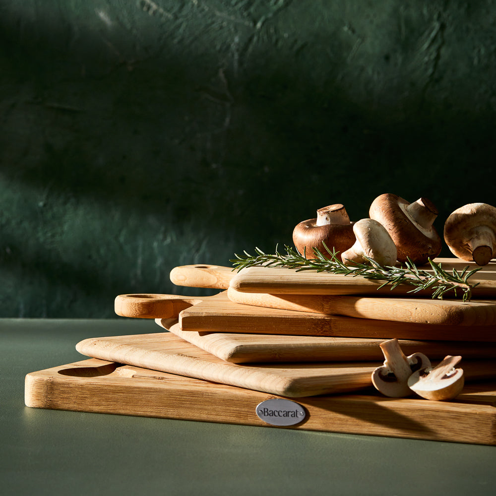 Wooden cutting boards of various sizes on dark green surface made of waterproof bamboo - Baccarat