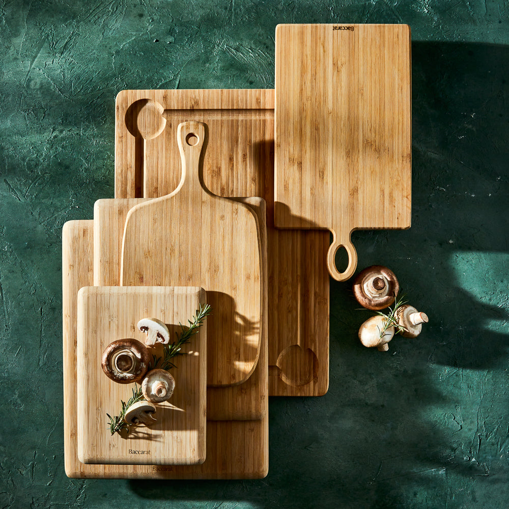 Wooden cutting boards of various sizes on dark green surface made of waterproof bamboo - Baccarat