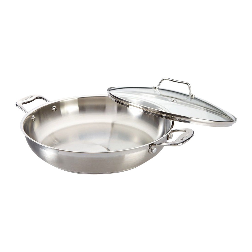 Overhead view of a stainless steel chef pan with lid and kitchen tools - Baccarat Iconix