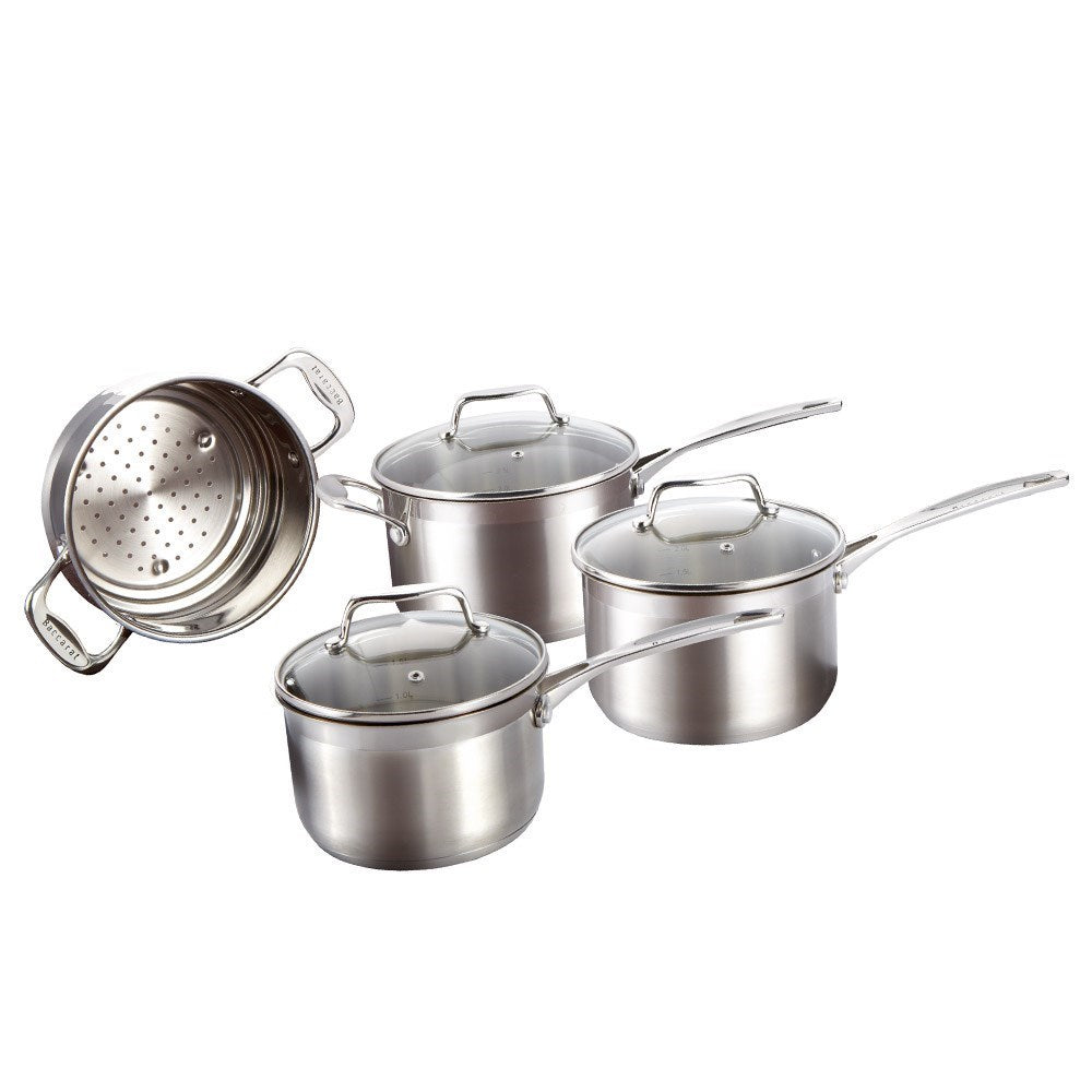A set of polished stainless steel cookware with fresh vegetables on a wooden board - Baccarat Iconix