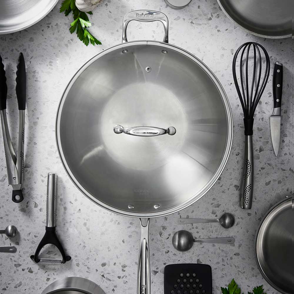 Stainless steel wok with lid and helper handle for efficient cooking in kitchen - Baccarat