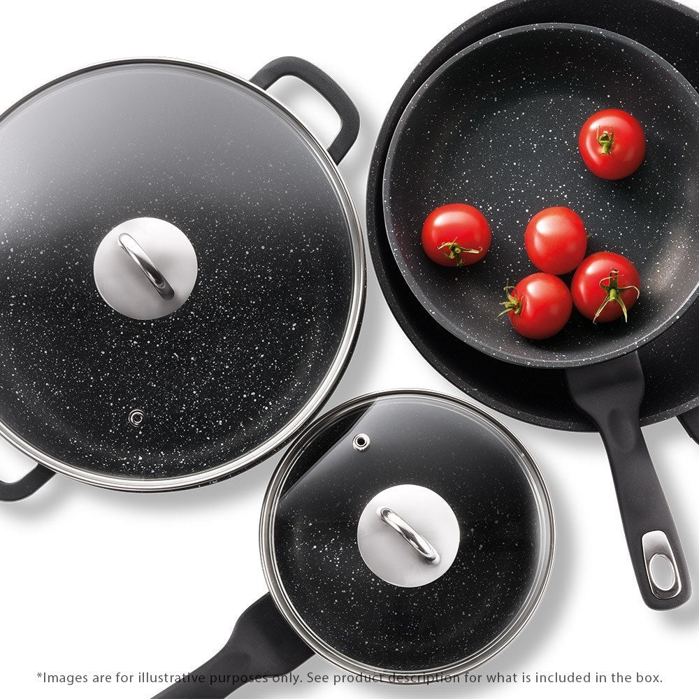 Cookware set including pots and frying pans arranged on a rustic wooden surface - Baccarat
