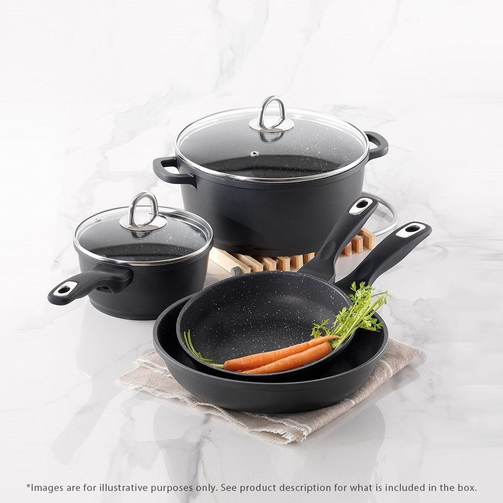 Cookware set including pots and frying pans arranged on a rustic wooden surface - Baccarat