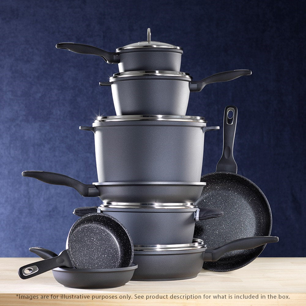 Cookware set including pots and frying pans arranged on a rustic wooden surface - Baccarat