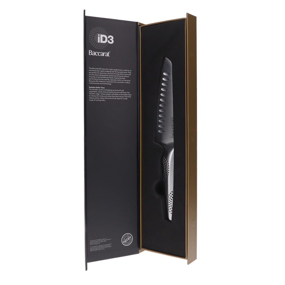 A knife on a wooden cutting board with chopped vibrant vegetables 20cm chefs knife - Baccarat
