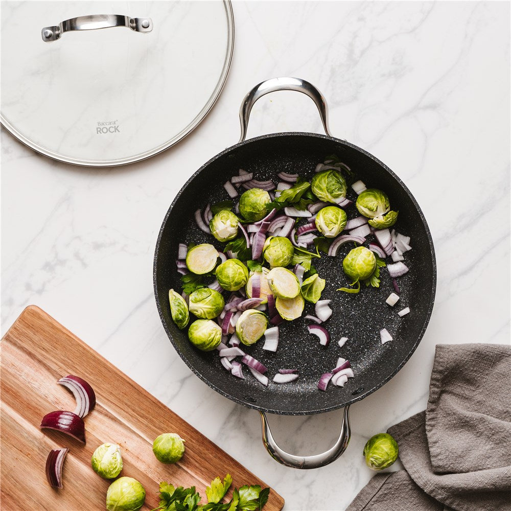 A top-down view of a frying pan with a smooth surface and sturdy handle grey stone - Baccarat