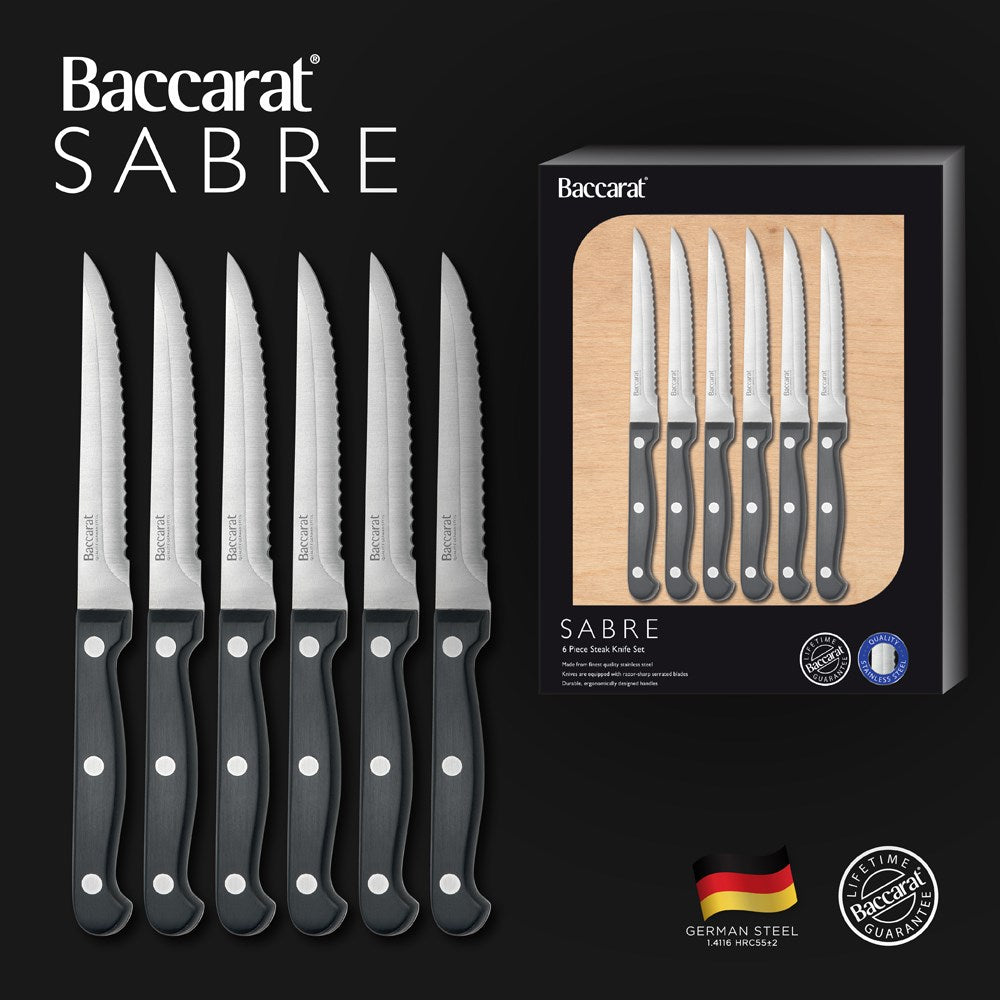 Six steak knives with black handles elegantly arranged outside packaging - Baccarat