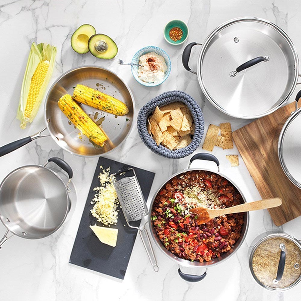 A 20-cm Baccarat Capri Saucepan with a lid filled with corn, chilli, and spices on a countertop
