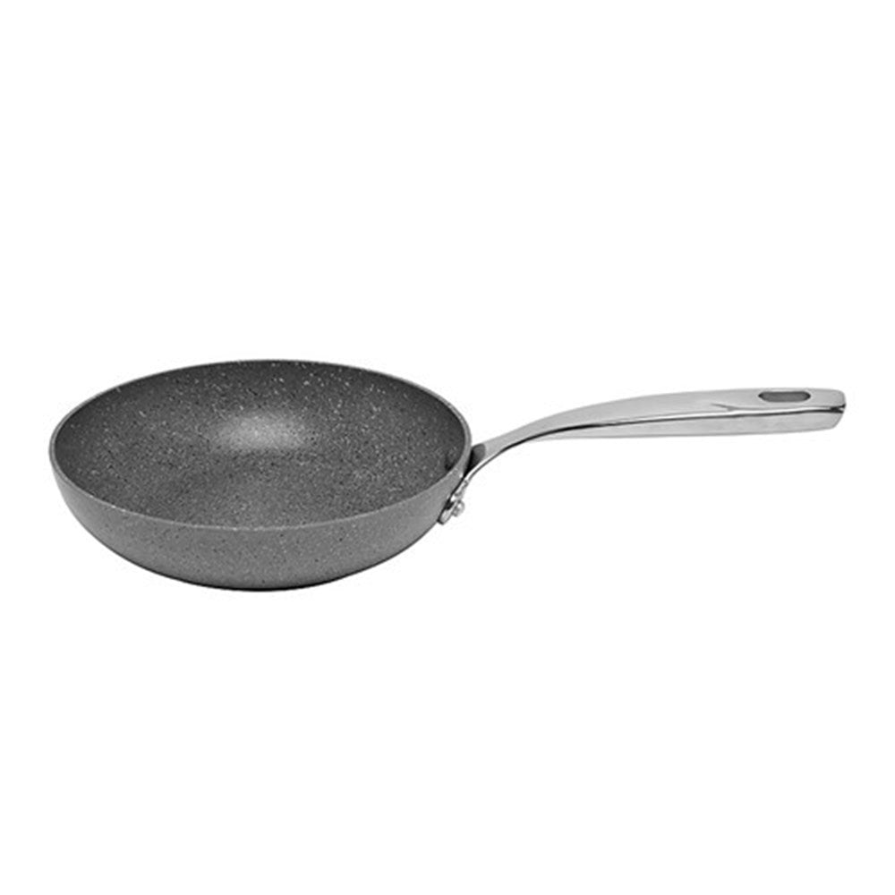 A fried egg is effortlessly slid onto a plate from a frying pan - grey non-stick cookware - Baccarat