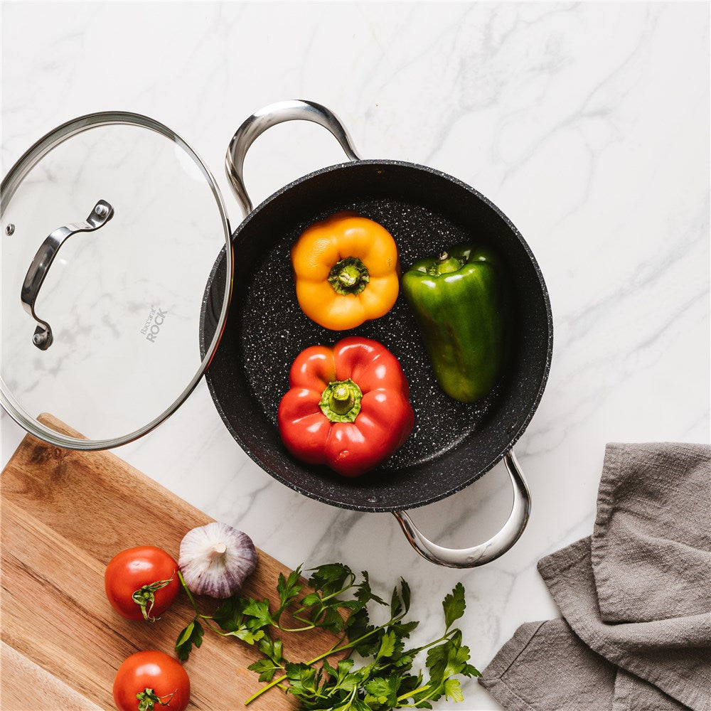 Overhead view of a colourful array of peppers on a marble surface - Baccarat Rock Casserole 24cm