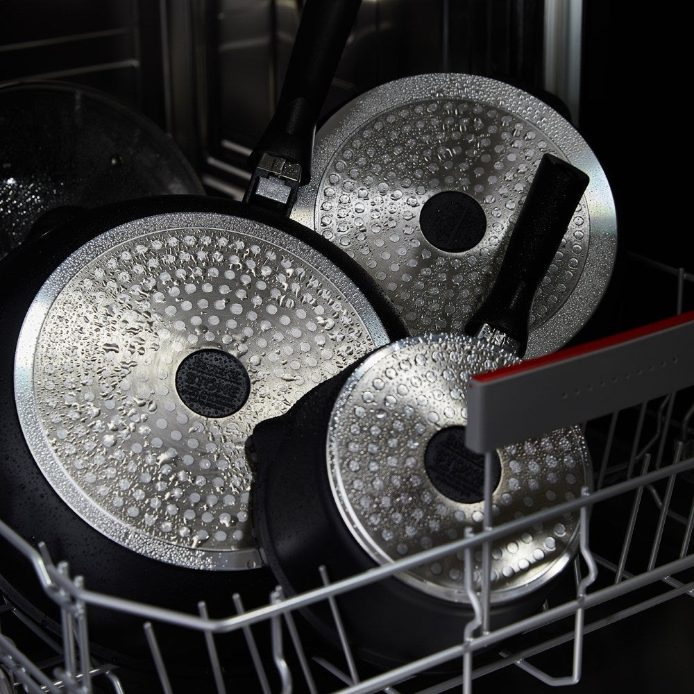 A modern kitchen featuring a sleek stir fry pan and cookware set in stone finish - Baccarat