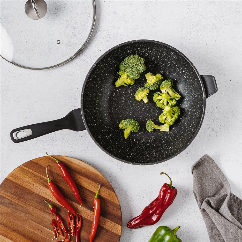 Nonstick wok with lid cooking icons and lifetime guarantee in black and white - Baccarat