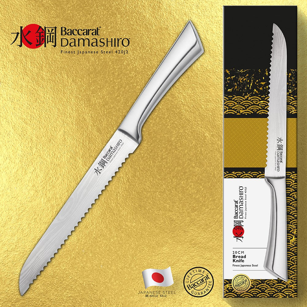 Golden brown bread slices beside a Baccarat Damashiro Bread Knife 20cm on a textured surface