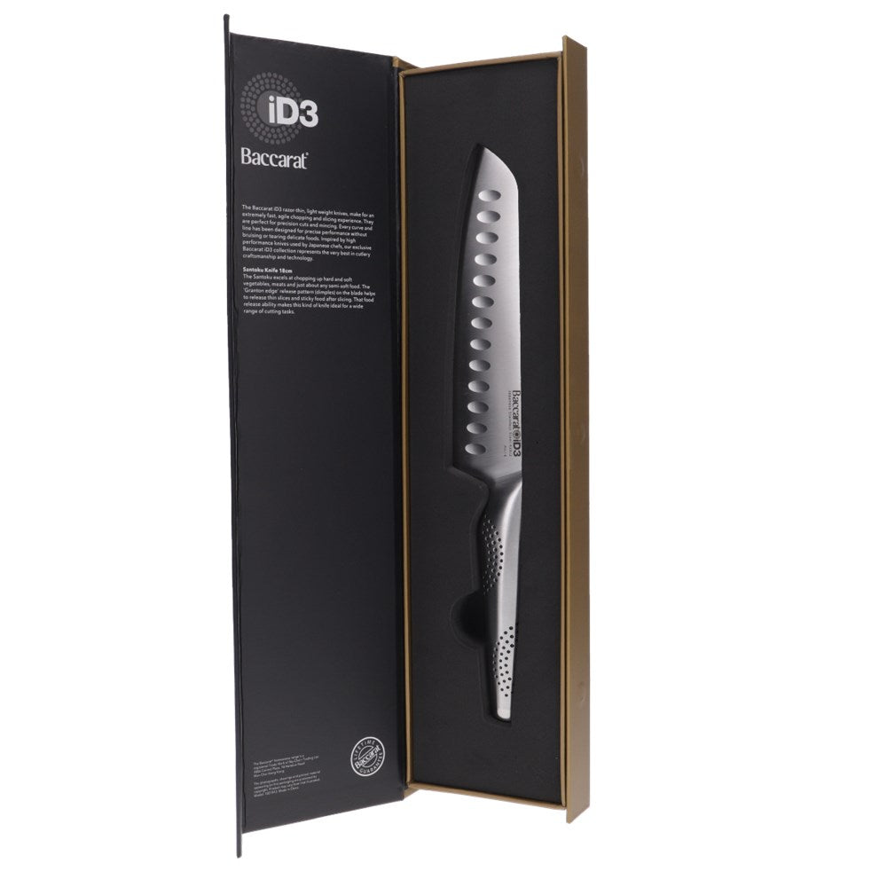A person slices a red onion on a wooden board with a sharp knife - Baccarat id3 santoku knife 18cm