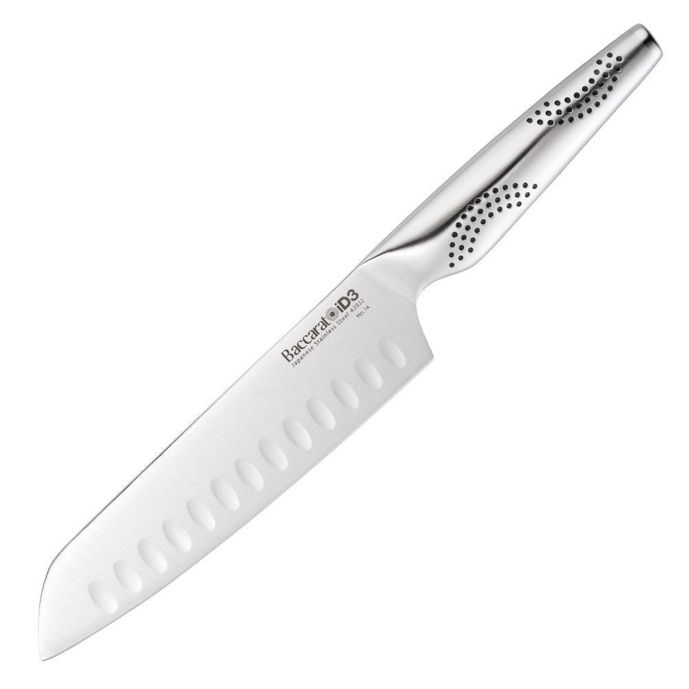 A person slices a red onion on a wooden board with a sharp knife - Baccarat id3 santoku knife 18cm
