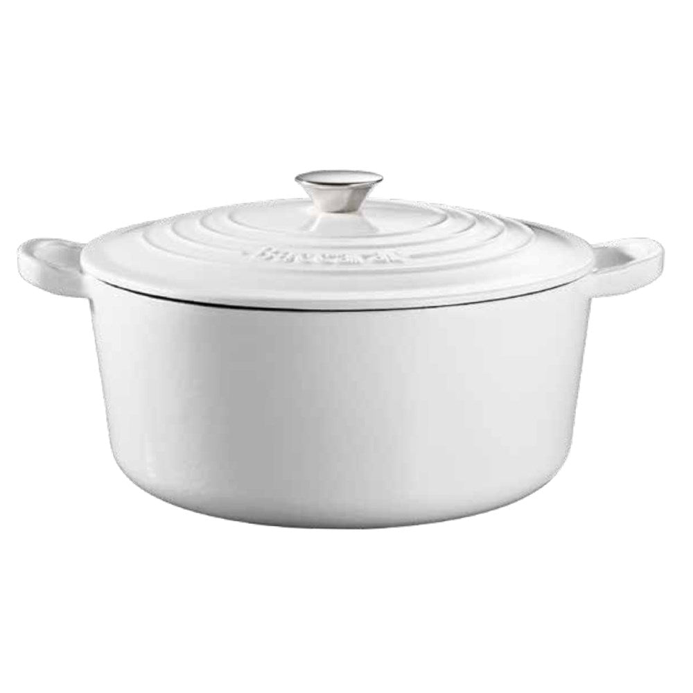 Black cast iron round French oven on stovetop with plates and greenery - Baccarat Le Connoisseur