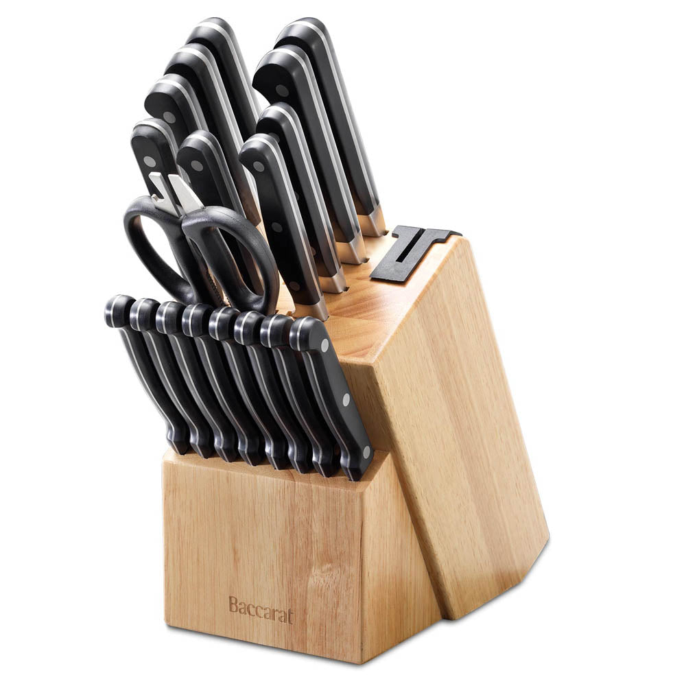 A selection of Sabre kitchen knives and scissors on cutting board with herbs and handles - Baccarat