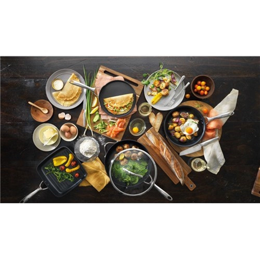 Vibrant cooked meals arranged on a wooden table in a 30cm non stick saute pan with lid - Baccarat