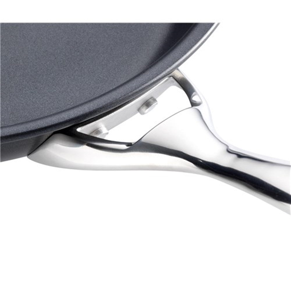 A stir fry pan filled with diced vegetables on a wooden board next to a grey cloth - Baccarat